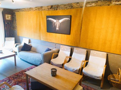 a room with chairs and a table and a couch at Laforestière, ruime authentieke vakantiewoning in de vallei van de Semois in Vresse-sur-Semois