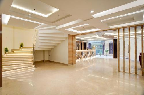 a hallway with stairs in a building at Gold The Prime Newly Built 2 Mins From Connaught Place and Railway Station in New Delhi
