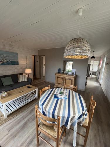 un salon avec une table et un canapé dans l'établissement Maison paisible à 100m de la Mer, à Bretignolles-sur-Mer