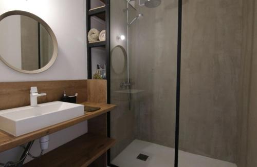 une salle de bain avec un lavabo et une douche avec un miroir dans l'établissement Beach house, à Cannes