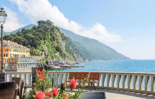 a bench sitting on a balcony overlooking the water at Stunning Apartment In Camogli With Wifi in Camogli