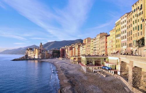 a group of buildings on a beach next to the water at Stunning Apartment In Camogli With Wifi in Camogli