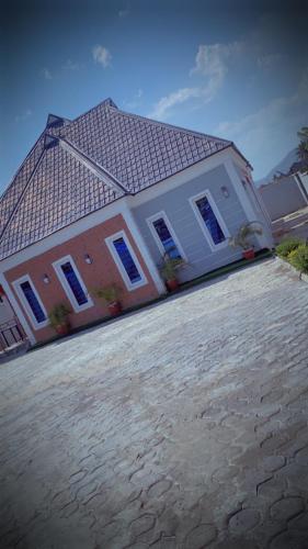 a house with a roof on top of it at Sea-Love Apartment in Ado Ekiti