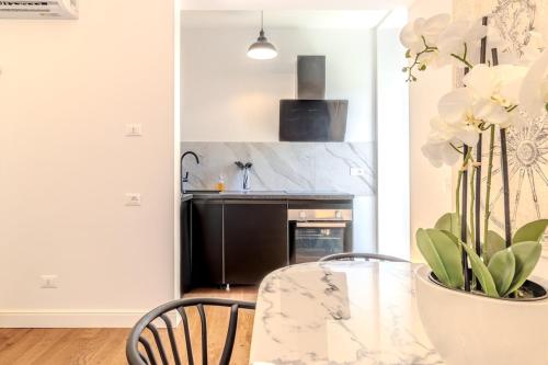 a kitchen with a dining table and a stove at Blue Como Luxury Apt#3 in Como