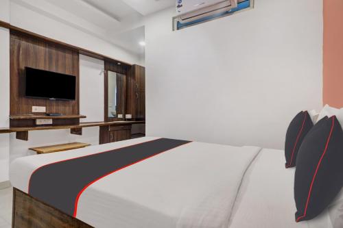 een slaapkamer met een bed en een tv erin bij Super Capital O Qualia Gachibowli in Hyderabad