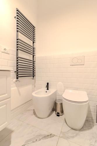 a white bathroom with a toilet and a sink at Blue Como Luxury Apt#3 in Como