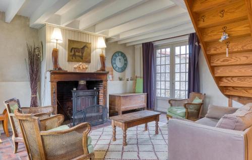 a living room with a fireplace and a couch at Stunning Home In Les Baux De Breteuil in Les Baux-de-Breteuil