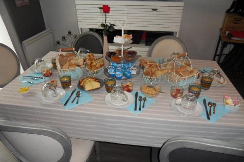 a table with food and baskets of food on it at Chambres d'Hôtes de la Grone in Argelès-sur-Mer