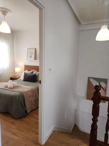 a bedroom with a bed in a white room at Laxe Piso Sol - Wifi y Netflix in Laxe