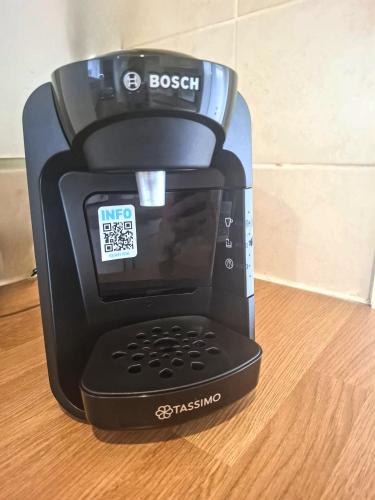 a black blender sitting on top of a wooden table at Modern Bright 3 Bedroom House in Lincolnshire