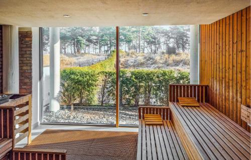 two benches in a room with a large window at Amber in Binz