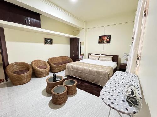 a hotel room with a bed and a table and chairs at Deivith Homestay Suite in Jowai