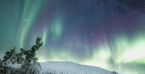an image of the northern lights in the sky at Lapland Hotels Sirkantähti in Levi
