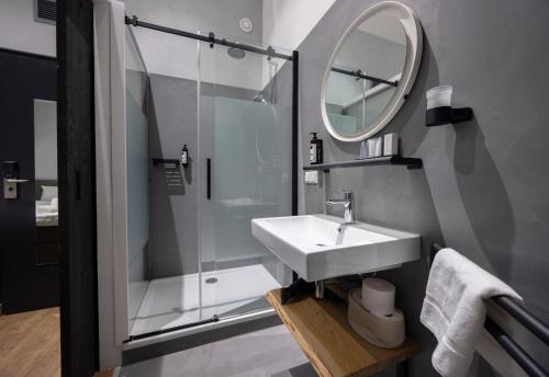 a bathroom with a sink and a shower and a mirror at "Het Wapen Van Willemstad" in Willemstad