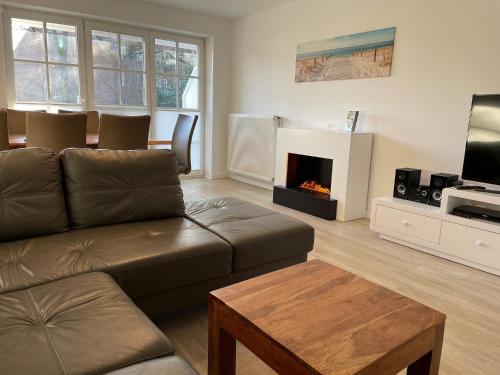 a living room with a couch and a fireplace at Ferienhaus Sonnenblick in Timmendorfer Strand