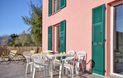 a patio with a table and chairs on a deck at Nice Home In San Salvatore With Wifi in San Salvatore