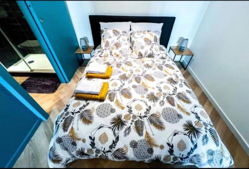 une chambre avec un lit avec un couvre-lit fleuri dans l'établissement Joli studio cœur de ville, à Avignon