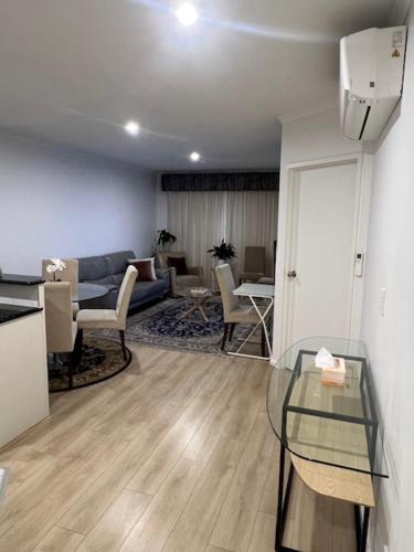 a living room with a couch and a table at ADELAIDE CBD APARTMENT - 3BR, 2BATH & CARPARK in Adelaide