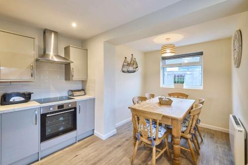 a kitchen with a table and chairs in a room at Host & Stay - Kittling Nook in Bamburgh