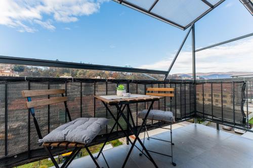 a balcony with a table and chairs on a roof at Flexible SelfCheckIns 122 - Zagreb - Bedroom - Loggia in Zagreb