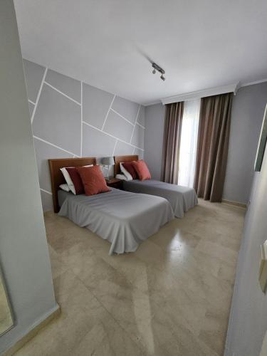 a bedroom with two beds and a window at Chalet with Sea Views in Fuengirola
