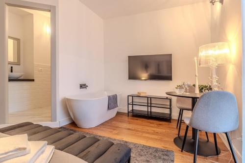 a living room with a bath tub and a table at Blue como Luxury suite in Como
