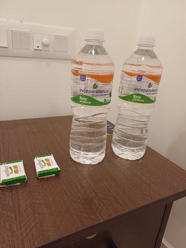 two bottles of water sitting on top of a table at Hotel Saai Residency in Tiruvannāmalai