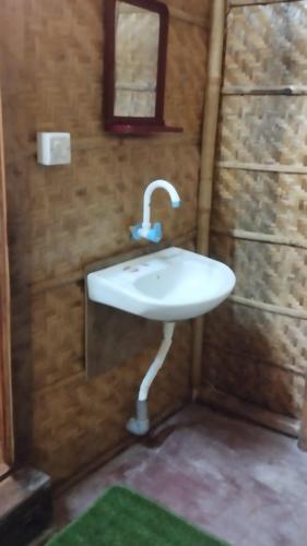 a bathroom with a white sink in a room at Sampigeheritage resot in Koppal