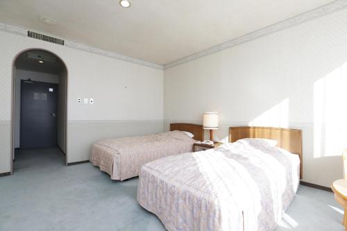 Una cama o camas en una habitación de ホテル レムナント鶯宿