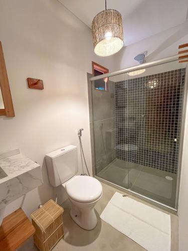 a bathroom with a toilet and a shower at Pousada Caminho De tatu in Pôrto de Pedras