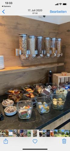 a counter with many bowls of food on it at Landgasthof Krone in Ramsberg
