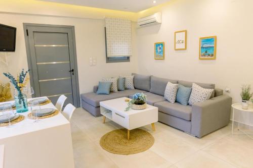 a living room with a couch and a table at Villa Eutuxia in Antikyra