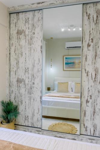 a mirror in a room with a bed in it at Villa Eutuxia in Antikyra