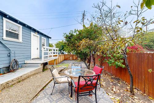 a patio with a table and chairs and a fence at Tremont Beach in Oceanside