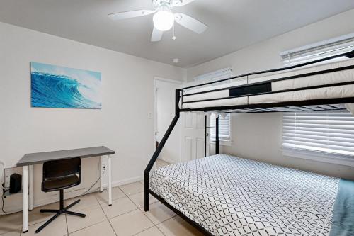 a bedroom with a bunk bed and a desk at Tremont Beach in Oceanside
