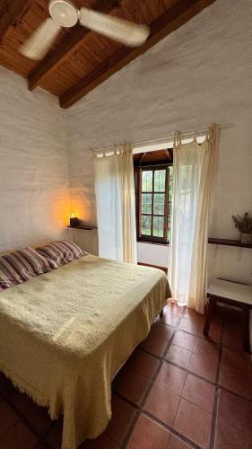 a bedroom with a large bed and a window at Casa cercana a plaza de Villa de las Rosas con patio y asador in Villa de Las Rosas