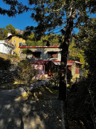 a house with a balcony on top of it at 1111 Villa - The Human Happiness project - MUKTESHWAR - ------------- ---------------- --------------------- ------------------------------ --------------------------------------------- ------------Jacuzzi - Private Property with Garden and Orchard in Mukteswar