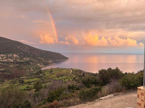 a rainbow in the sky over a body of water at Afroditi 2 in Angón