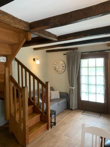 un salon avec un escalier et une fenêtre dans l'établissement Countryside Retreat in Brittany 2 Bedrooms Sleeps 4 Pet Friendly Heated Swimming Pool Free Wifi, à Plouguenast Langast