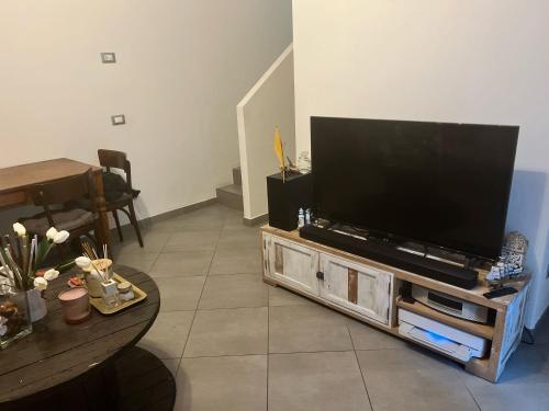 a living room with a large flat screen tv at inCentRo in Cremona