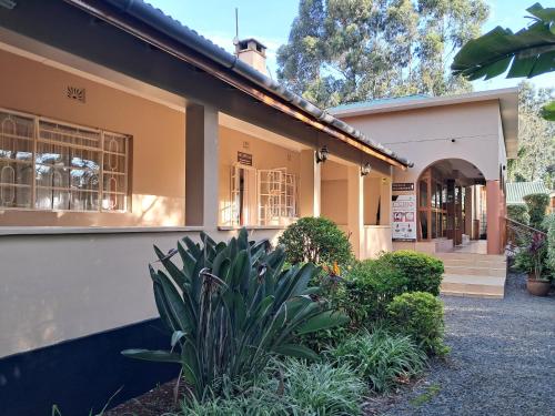 a house with a plant in front of it at GRACEMONT Guesthouse in Eldoret