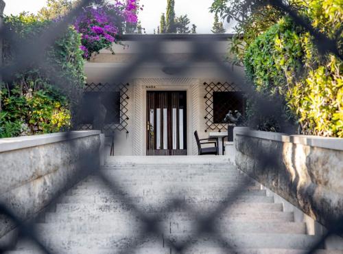a staircase leading up to a house with a door at Villa Nada - Unique and Artistic in Korčula