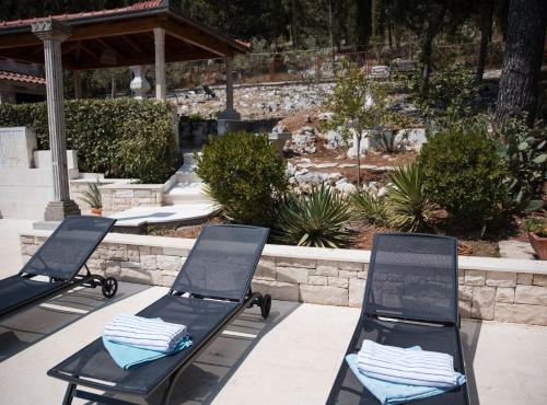 two black folding chairs sitting on a patio at Villa Nada - Unique and Artistic in Korčula