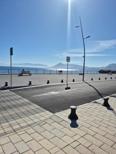 a street next to a beach with a street light at Pandora in Porticello