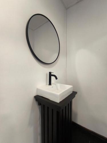 a bathroom with a sink and a mirror on the wall at Seahorse Diver Guesthouse in Perhentian Islands