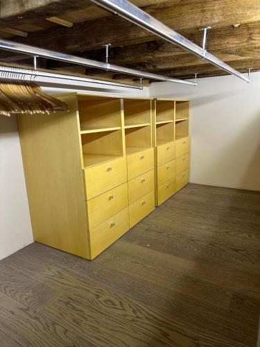 an empty room with wooden cabinets and shelves at Suite Burotti - Cherasco in Cherasco