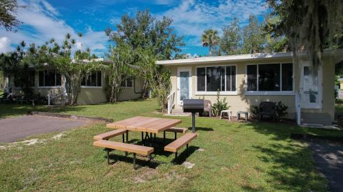 a picnic table in front of a house at Lakeside Cottages in Lake Placid