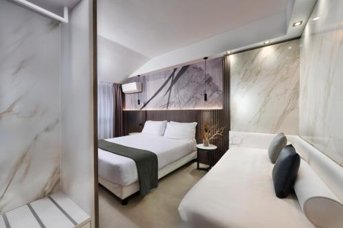 a hotel room with a bed and a couch at Hotel Metropolitan in Bologna