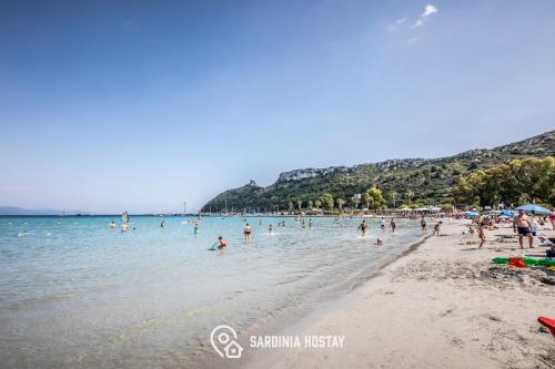 a group of people in the water at a beach at Villa Marcello in Cagliari