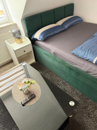a room with a bed and a table with a hat on it at Ferienwohnung Centro 2 in Bremerhaven